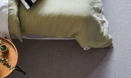 Textured grey carpet in an industrial-style bedroom